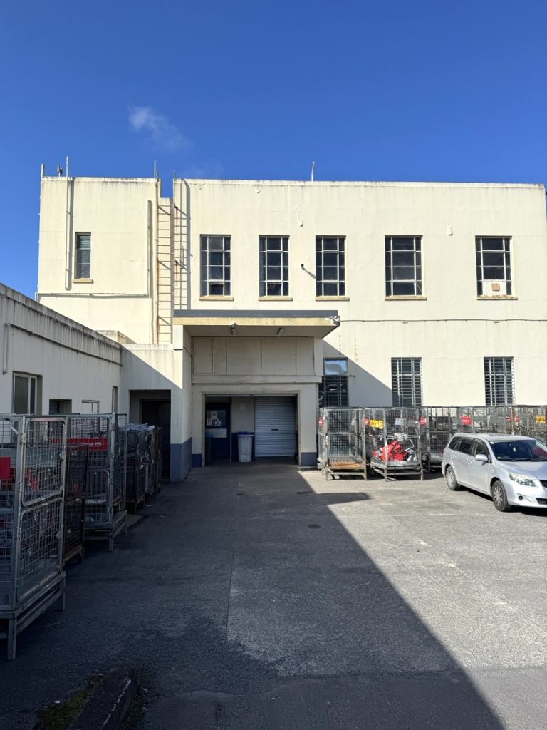 Rear exterior of The Exchange building showing service access and upper-level windows