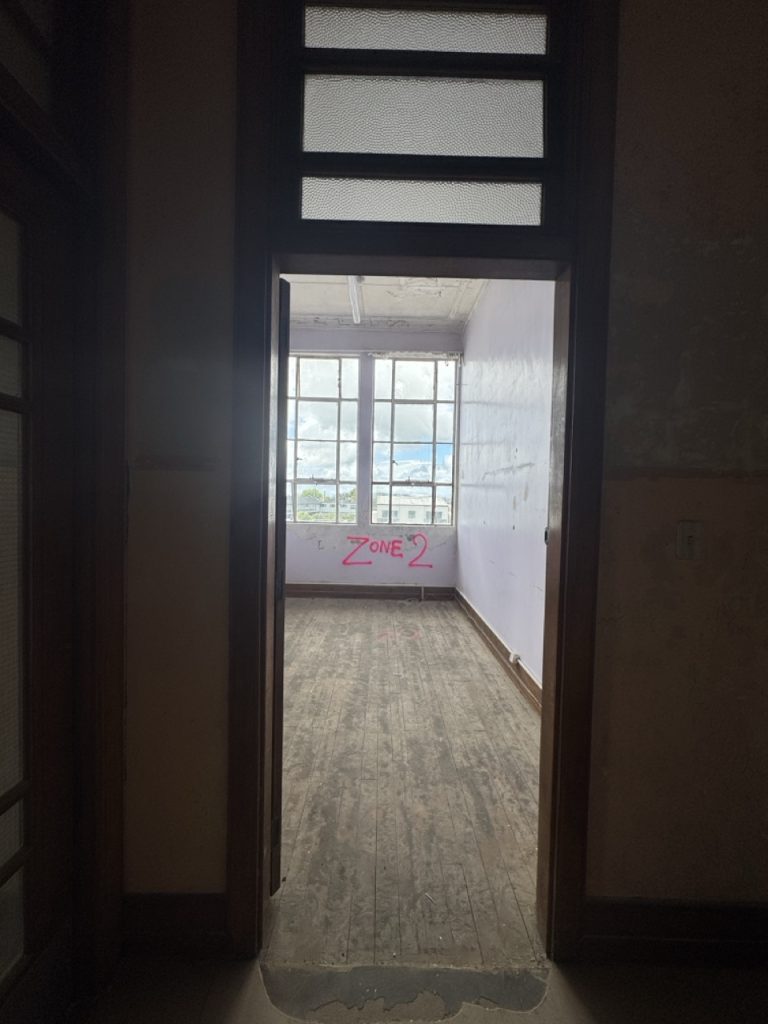Doorway leading into an interior room at The Exchange with windows and natural light